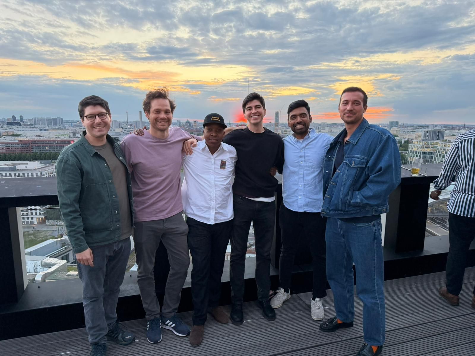 Group photo on a Berlin rooftop at sunset during GTM Night
