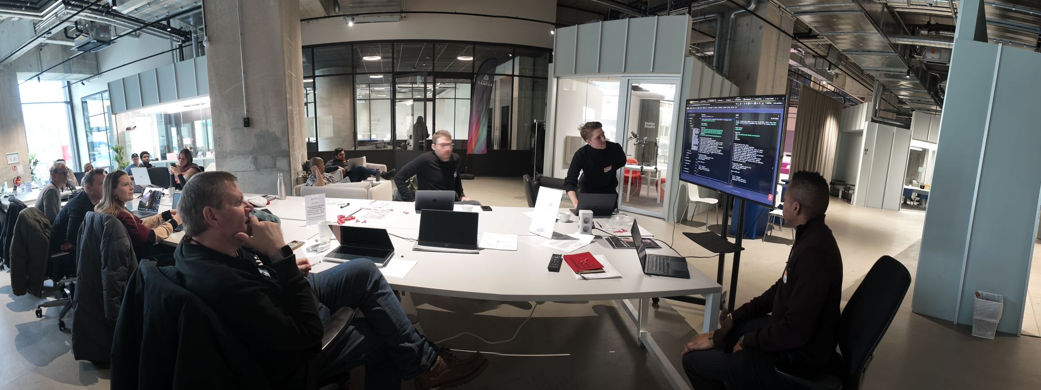 Patrick and the QONQA team leading an n8n workshop, presenting automation workflows to a room of attendees